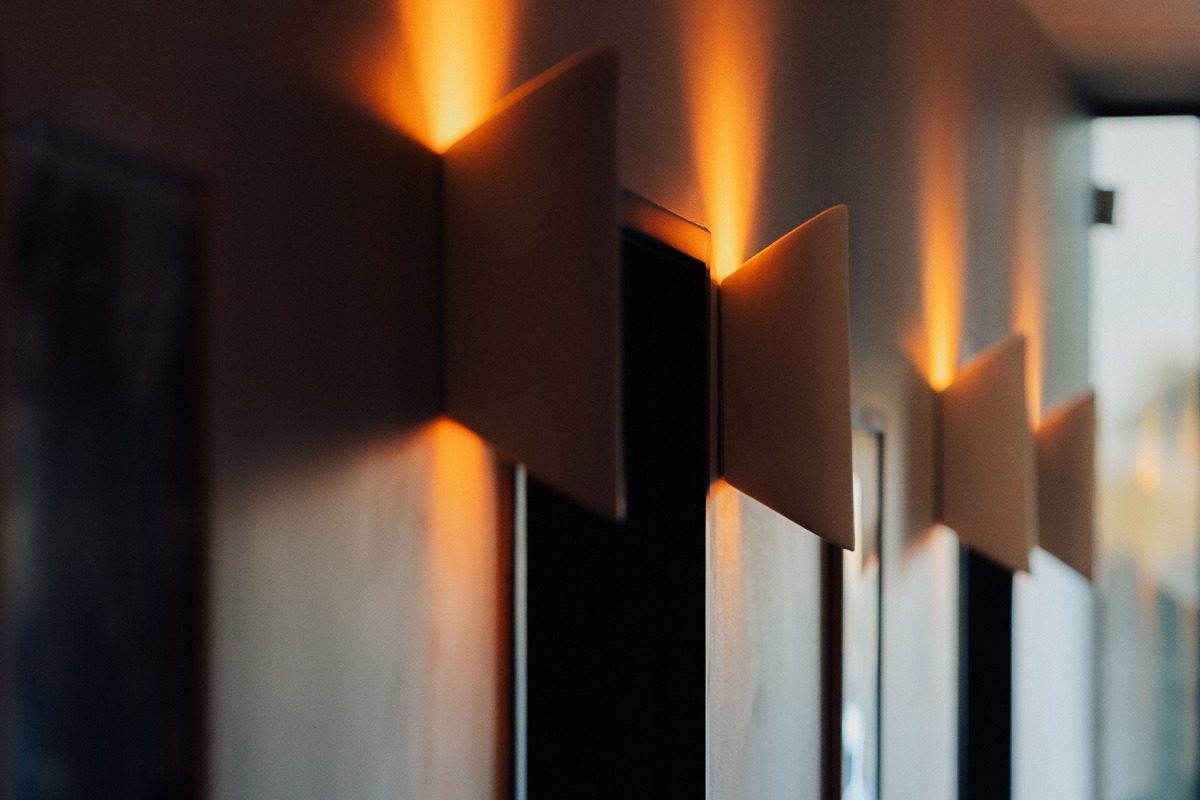 Warm sconce lighting in the Green Room hallway