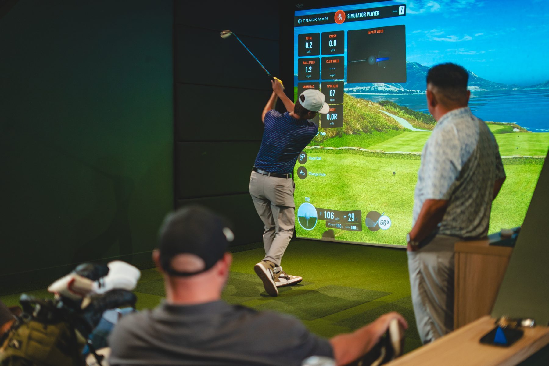 League night at Green Room Golf Club, a player teeing off while others watch