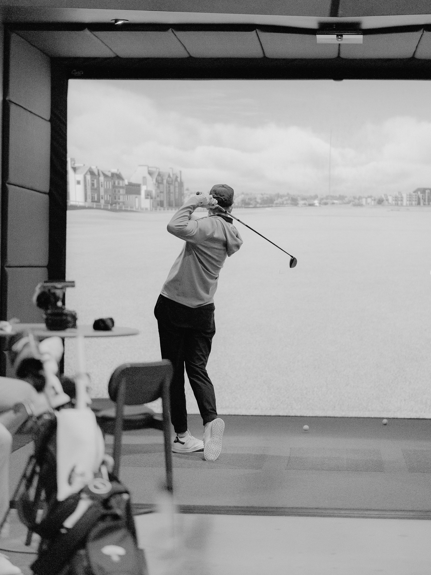 A player mid swing in a Green Room bay